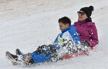 People enjoy sledging on snow-covered Velebit Mountain in Croatia