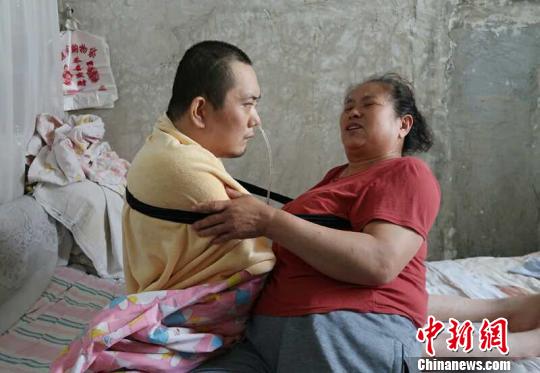 身體日漸衰老的梁青蘭每次幫兒子翻身、坐立，全身的衣物都要濕透一次?！∩忻鱾b 攝